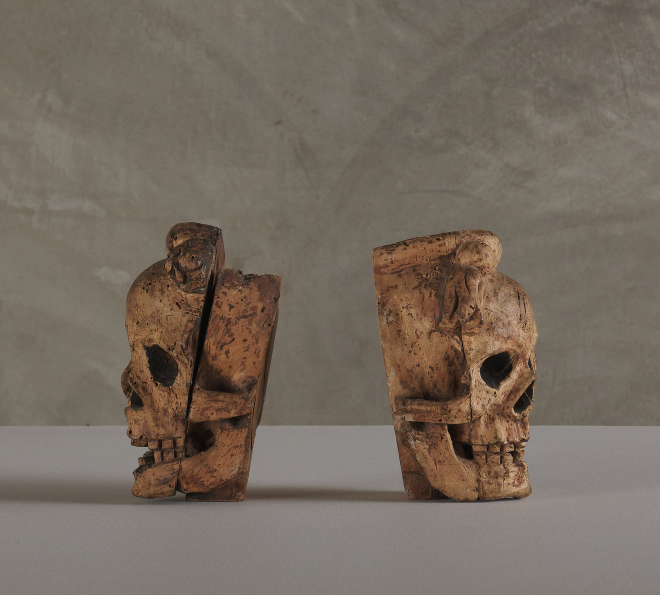 2 CARVED WOOD SKULL FORM ARCHITECTURAL ORNAMENTS