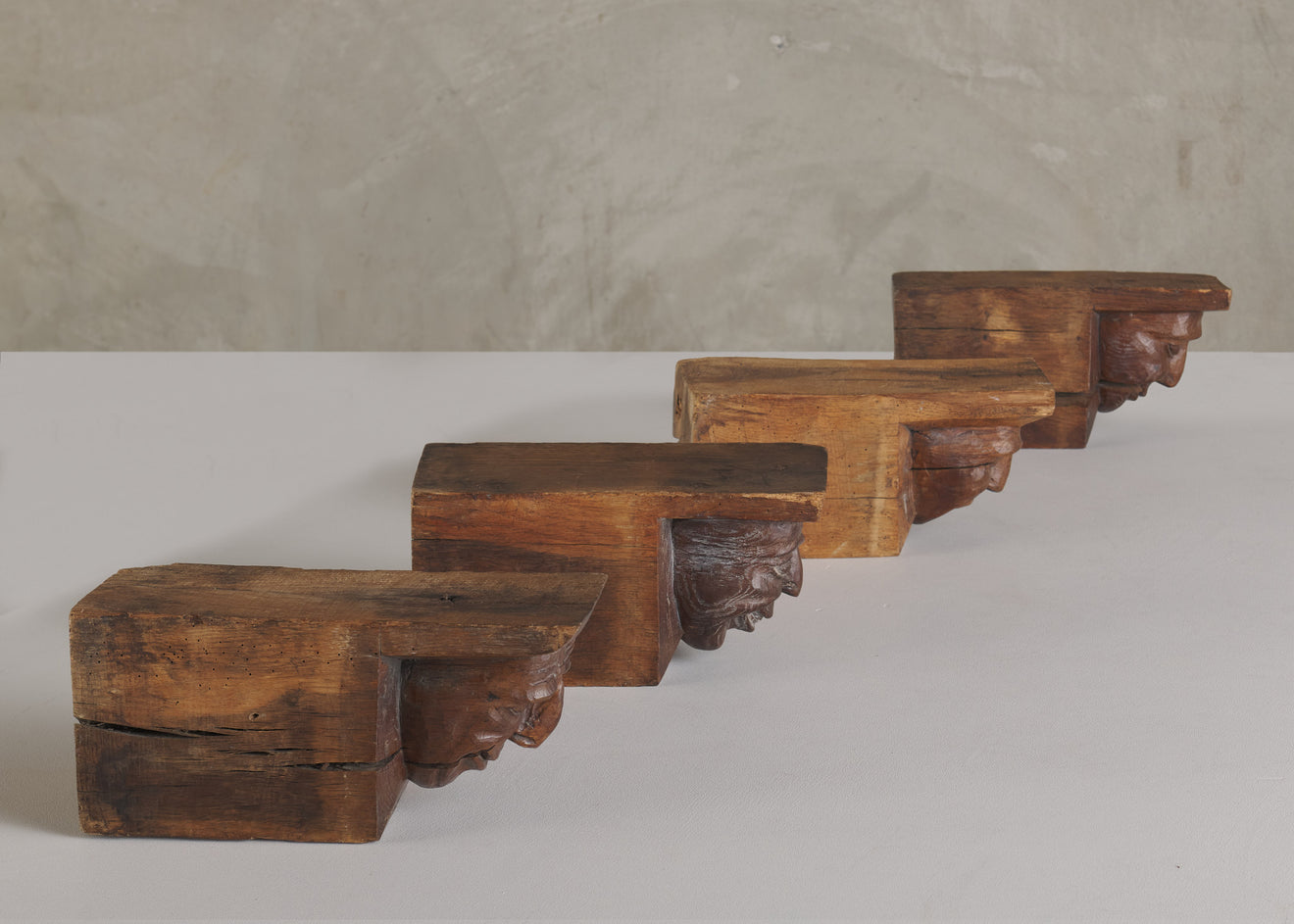 SET OF FOUR WOOD CARVED CORBELS WITH GROTESQUE FACES