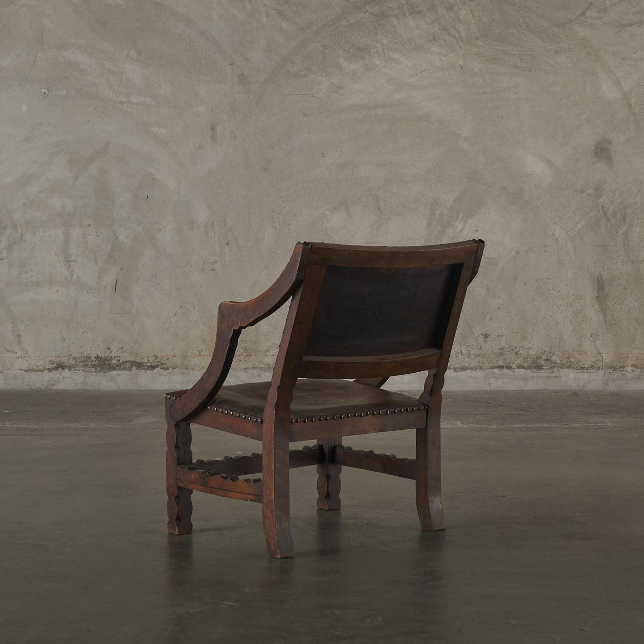 SPANISH COLONIAL LEATHER STUDDED LOW ARM CHAIR