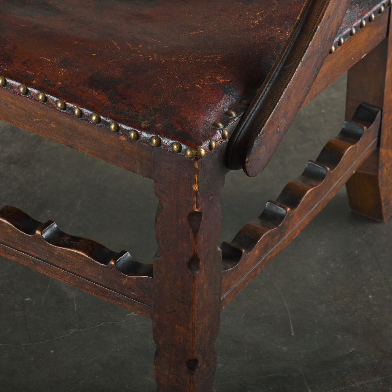 SPANISH COLONIAL LEATHER STUDDED LOW ARM CHAIR