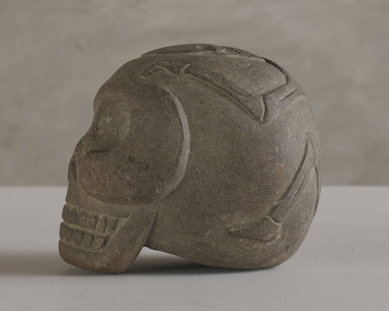 BASALT SKULL WITH CARVED SKELETON