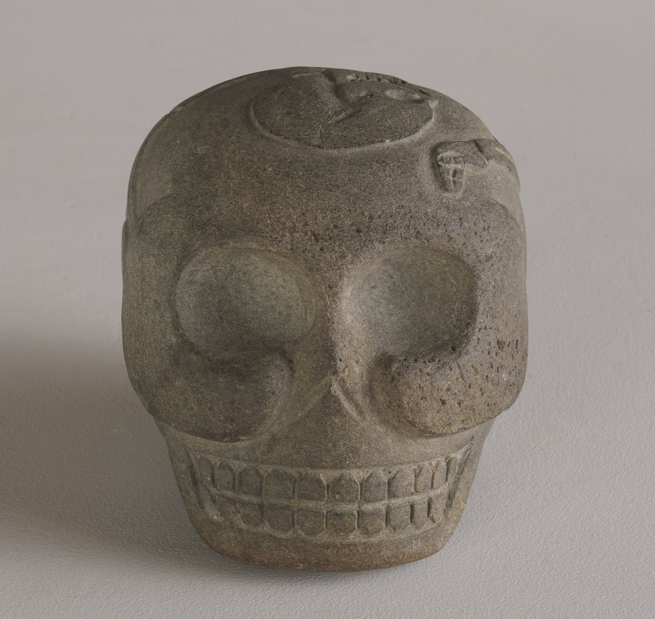 BASALT SKULL WITH CARVED SKELETON