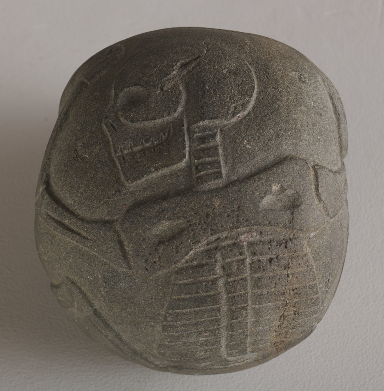 BASALT SKULL WITH CARVED SKELETON