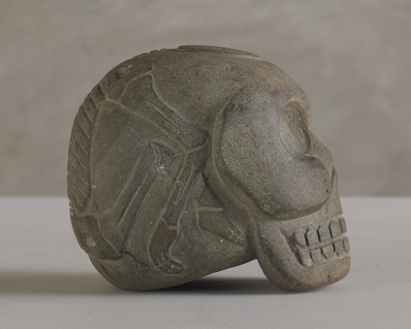 BASALT SKULL WITH CARVED SKELETON