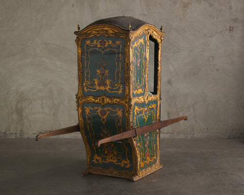 ITALIAN CARVED AND GILDED SEDAN CHAIR WITH ORIGINAL INTERIOR AND GLASS