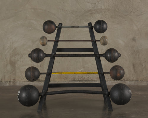 COLLECTION OF ANTIQUE BARBELLS ON STEEL MOUNT