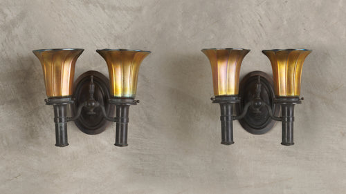 PAIR OF BRONZE SCONCES IN THE MANNER OF TIFFANY STUDIOS WITH STEUBEN SHADES, 20th C
