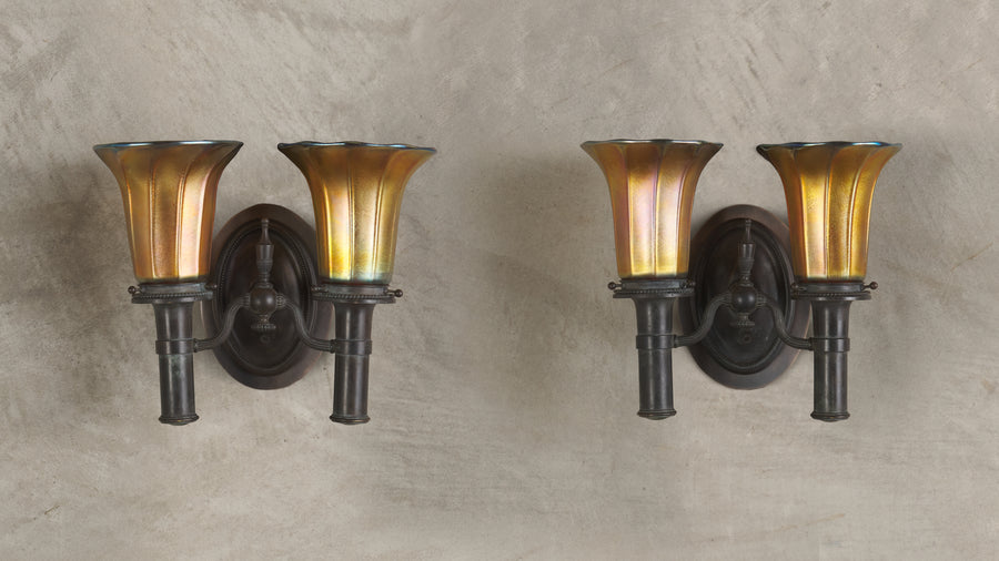 PAIR OF BRONZE SCONCES IN THE MANNER OF TIFFANY STUDIOS WITH STEUBEN SHADES, 20th C