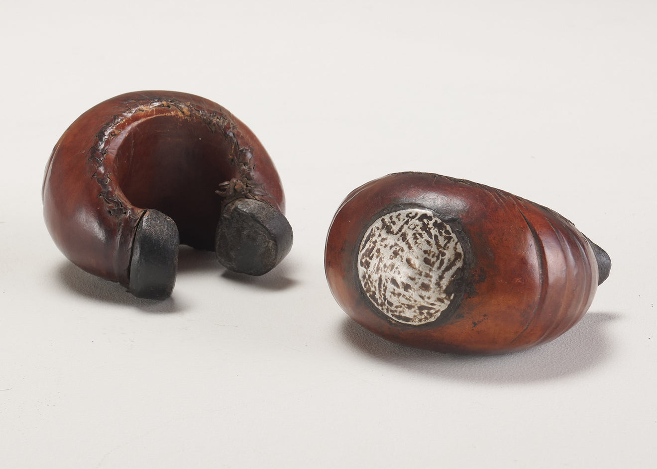 PAIR OF LEATHER MOUNTED BENIN CUFF BRACELETS, AFRICA, 20TH C