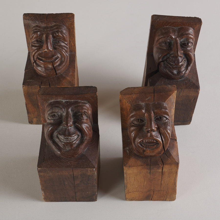 SET OF FOUR WOOD CARVED CORBELS WITH GROTESQUE FACES