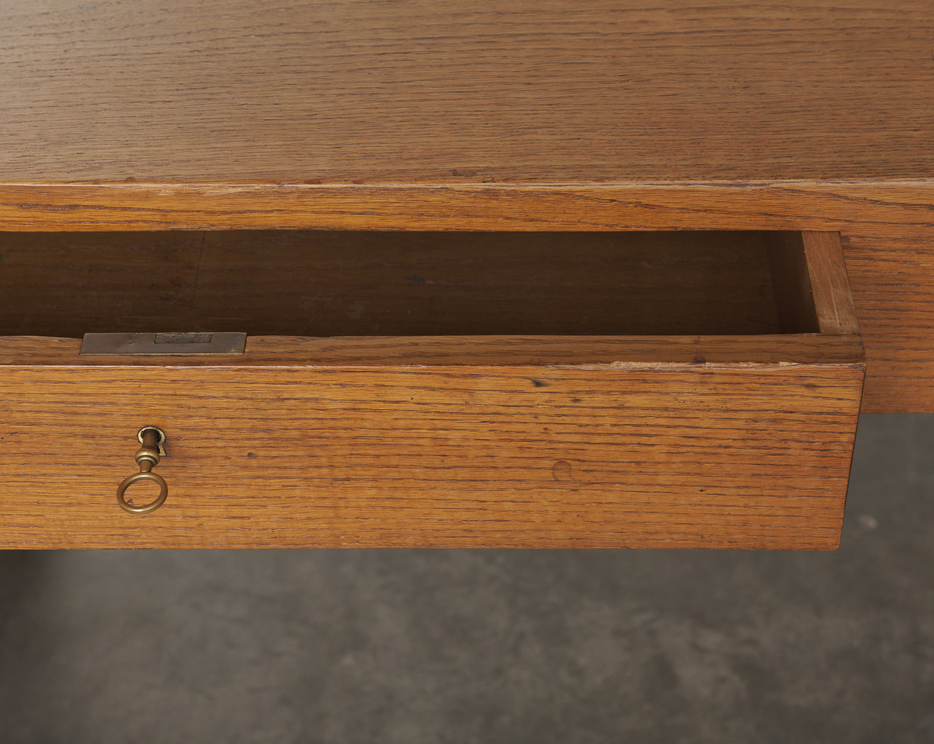 TWO DRAWER OAK DESK IN THE MANNER OF ROBSJOHN GIBBINGS